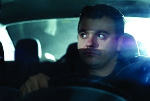 Man in Car Eyeing Bright Lights Behind
